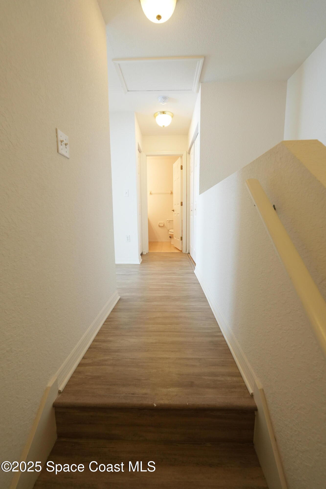 110 Turpial Way, Unit 103 Melbourne, FL 32901 - Photo 13 of 20 a view of a hallway with wooden floor