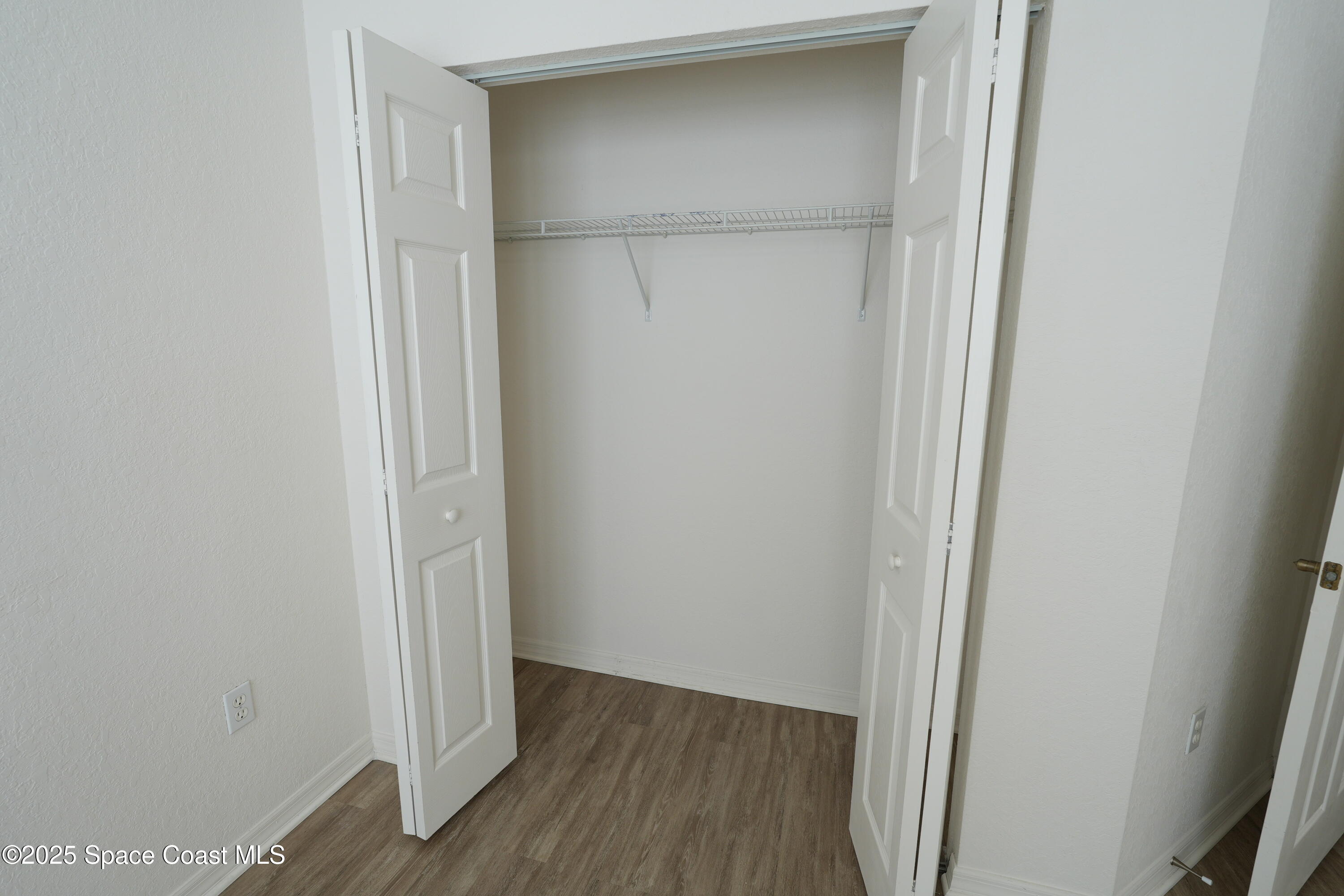 110 Turpial Way, Unit 103 Melbourne, FL 32901 - Photo 17 of 20 a view of a hallway with wooden floor