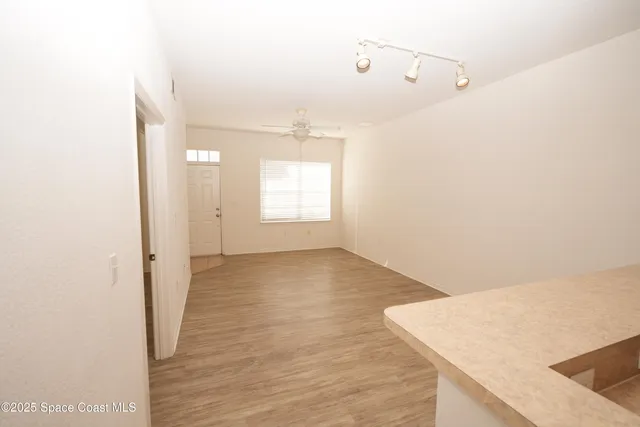 a view of a kitchen with wooden floor and staircase