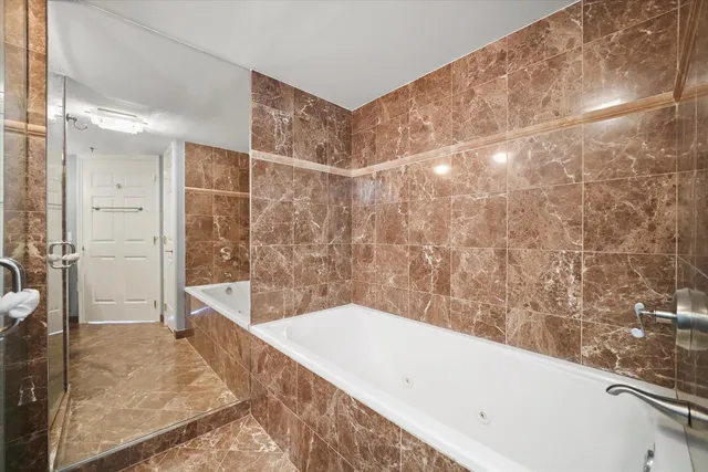 a bathroom with a bathtub and shower