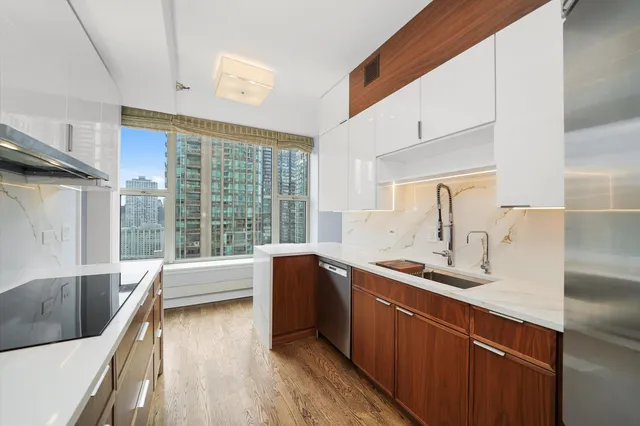 a kitchen with stainless steel appliances granite countertop a sink and a stove