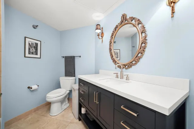 a bathroom with a toilet a sink and a mirror