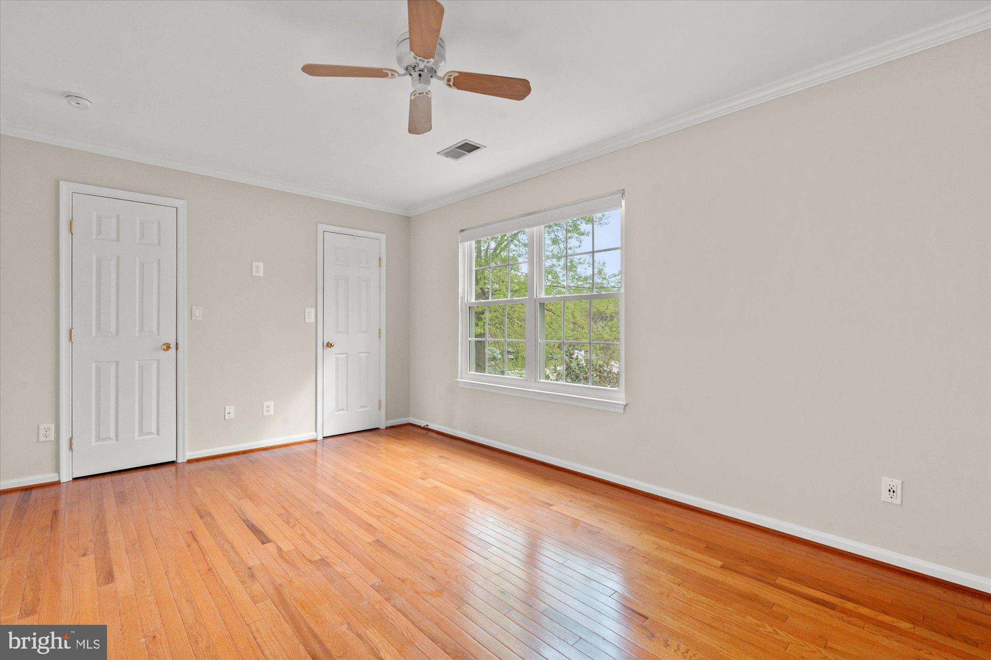 6 West Glebe Road Alexandria, VA 22305 - Photo 28 of 45 an empty room with wooden floor chandelier fan and windows