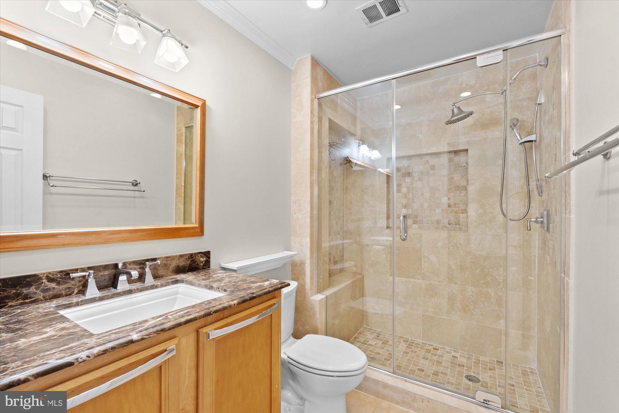 6 West Glebe Road Alexandria, VA 22305 - Photo 31 of 45 a bathroom with a granite countertop sink toilet a mirror and shower