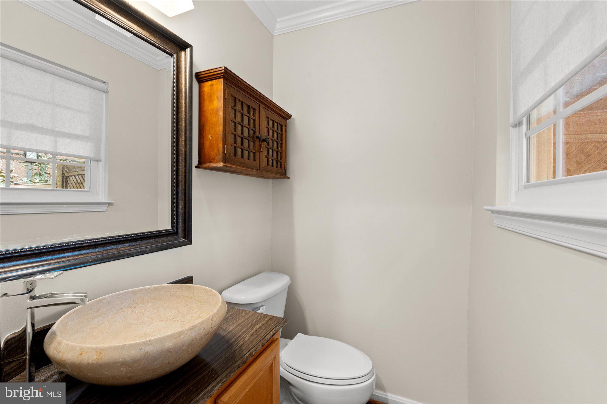 6 West Glebe Road Alexandria, VA 22305 - Photo 32 of 45 a bathroom with a toilet a sink and mirror