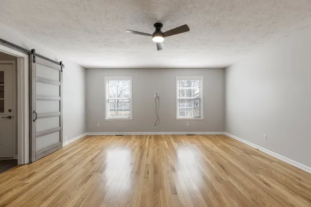 wooden floor in an empty room with a window