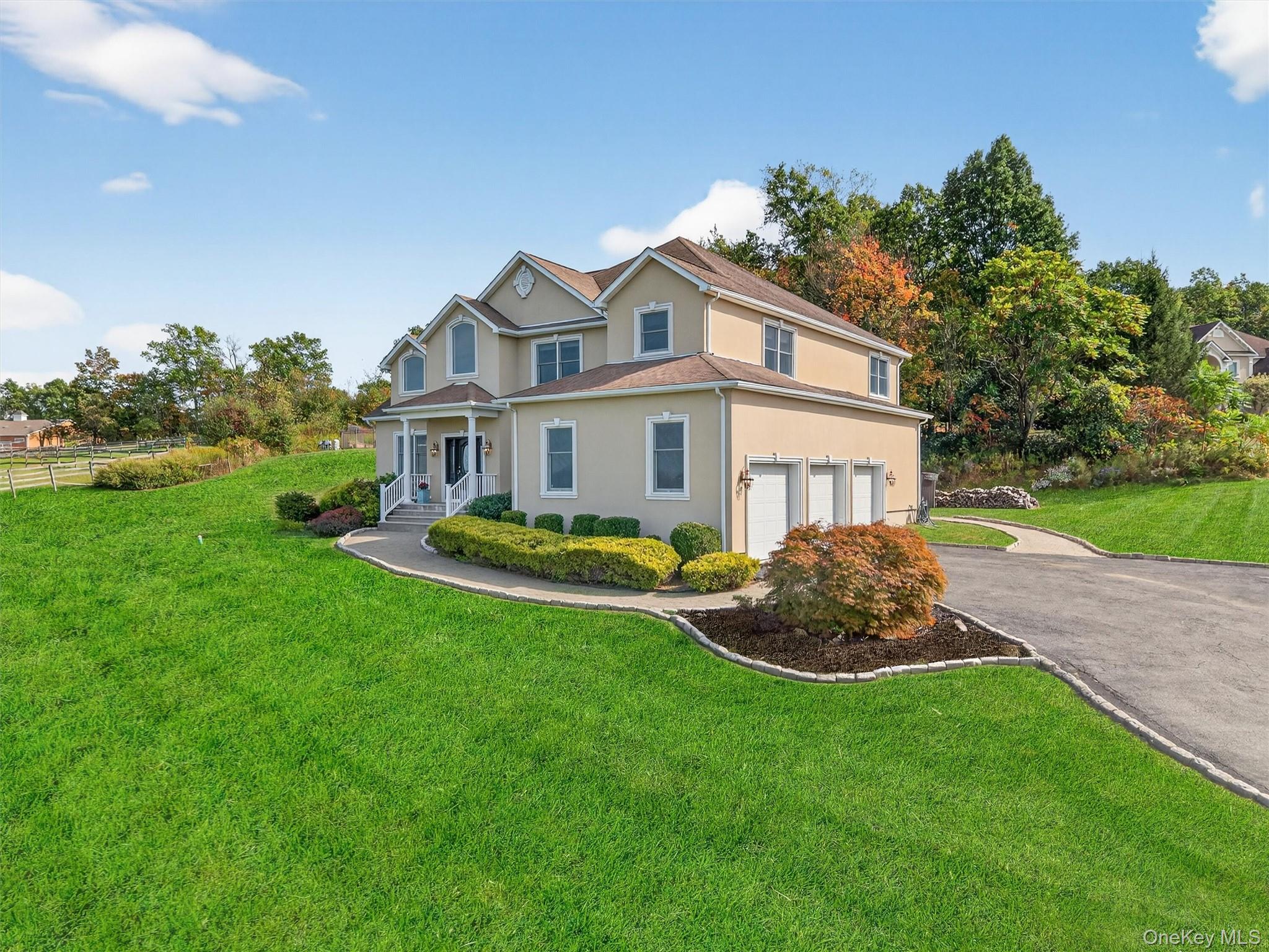 a front view of a house with a garden and yard