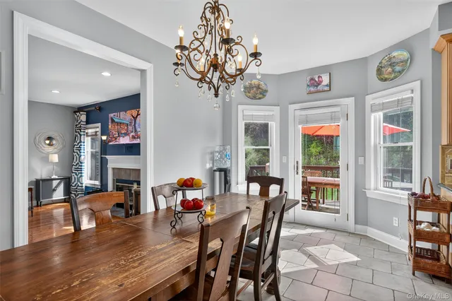 a dining room with furniture a chandelier and wooden floor