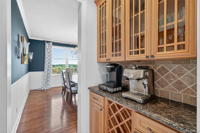 a kitchen with a stove and a white wooden cabinets