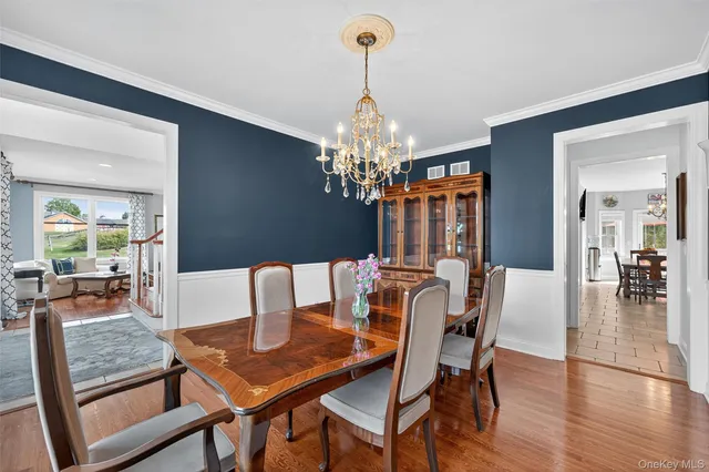 a view of a dining room with furniture wooden floor and chandelier