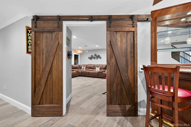 a view of a hallway and a livingroom with furniture