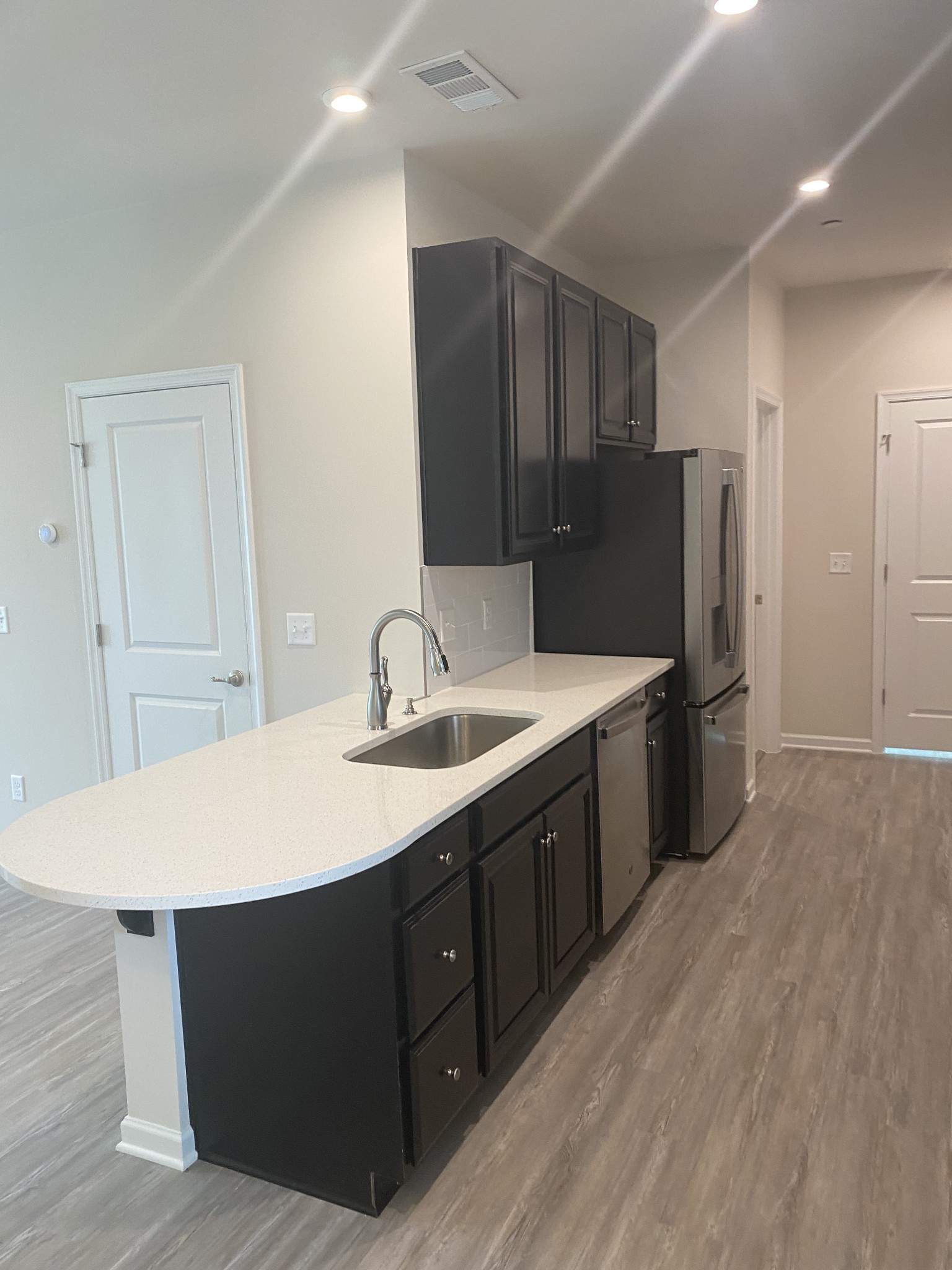 107 Keelon Gap Road, Unit 180A Spring Hill, TN 37174 - Photo 3 of 16 a kitchen with stainless steel appliances a sink and a refrigerator