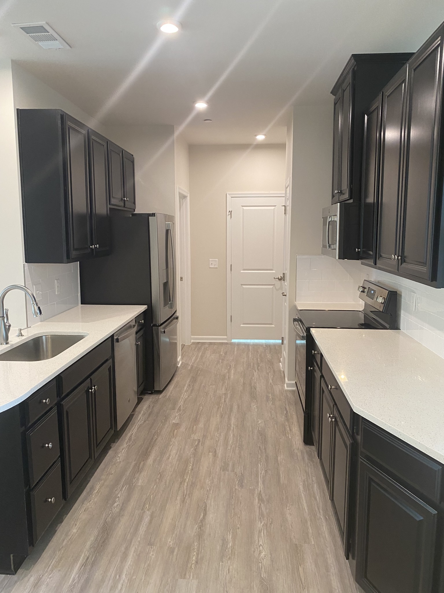 107 Keelon Gap Road, Unit 180A Spring Hill, TN 37174 - Photo 6 of 16 a large kitchen with a sink and refrigerator