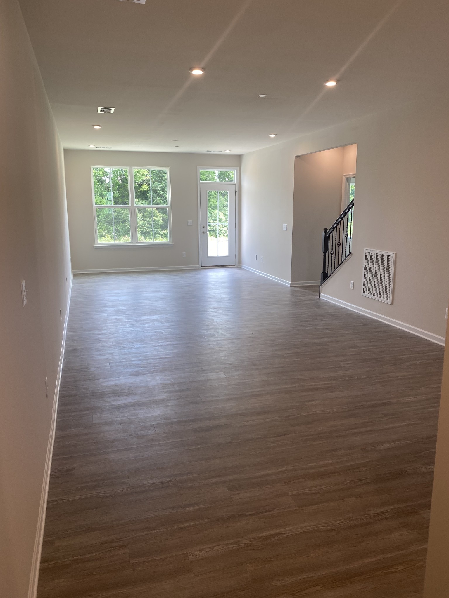 107 Keelon Gap Road, Unit 180A Spring Hill, TN 37174 - Photo 9 of 16 an empty room with wooden floor and windows