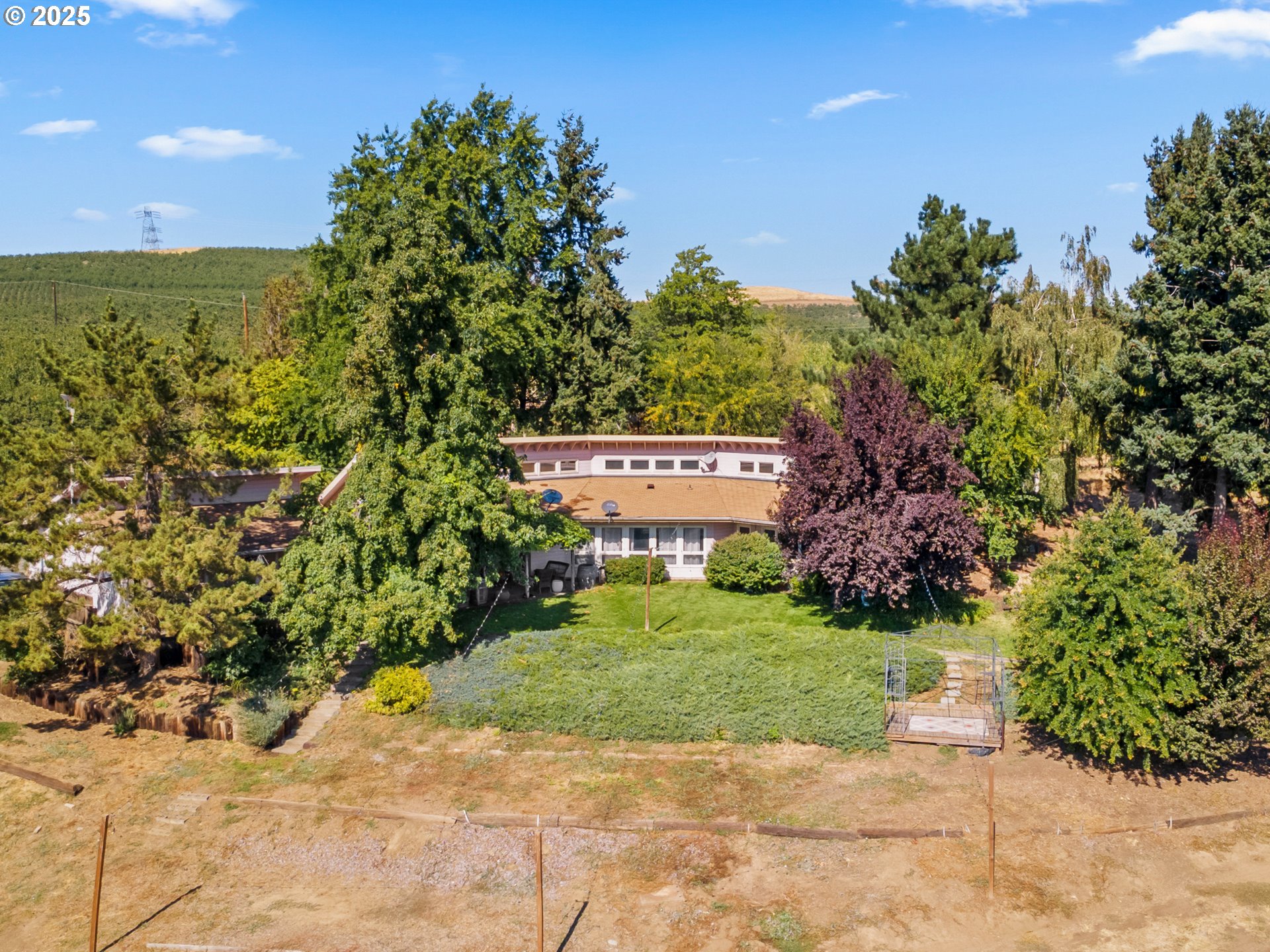 2018 Steele Road The Dalles, OR 97058 - Photo 2 of 36 a view of a garden with a building in the background