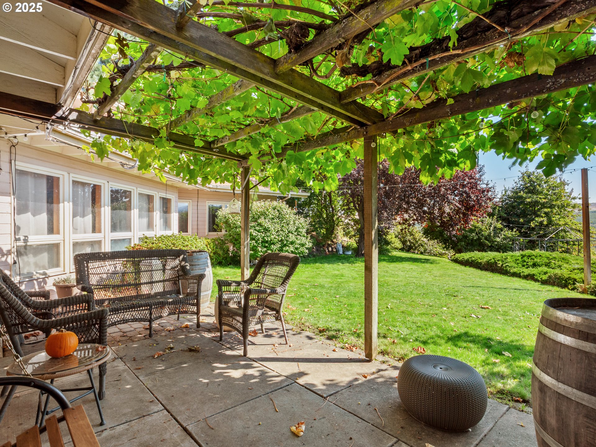 2018 Steele Road The Dalles, OR 97058 - Photo 28 of 36 a view of a patio with a table chairs and a backyard