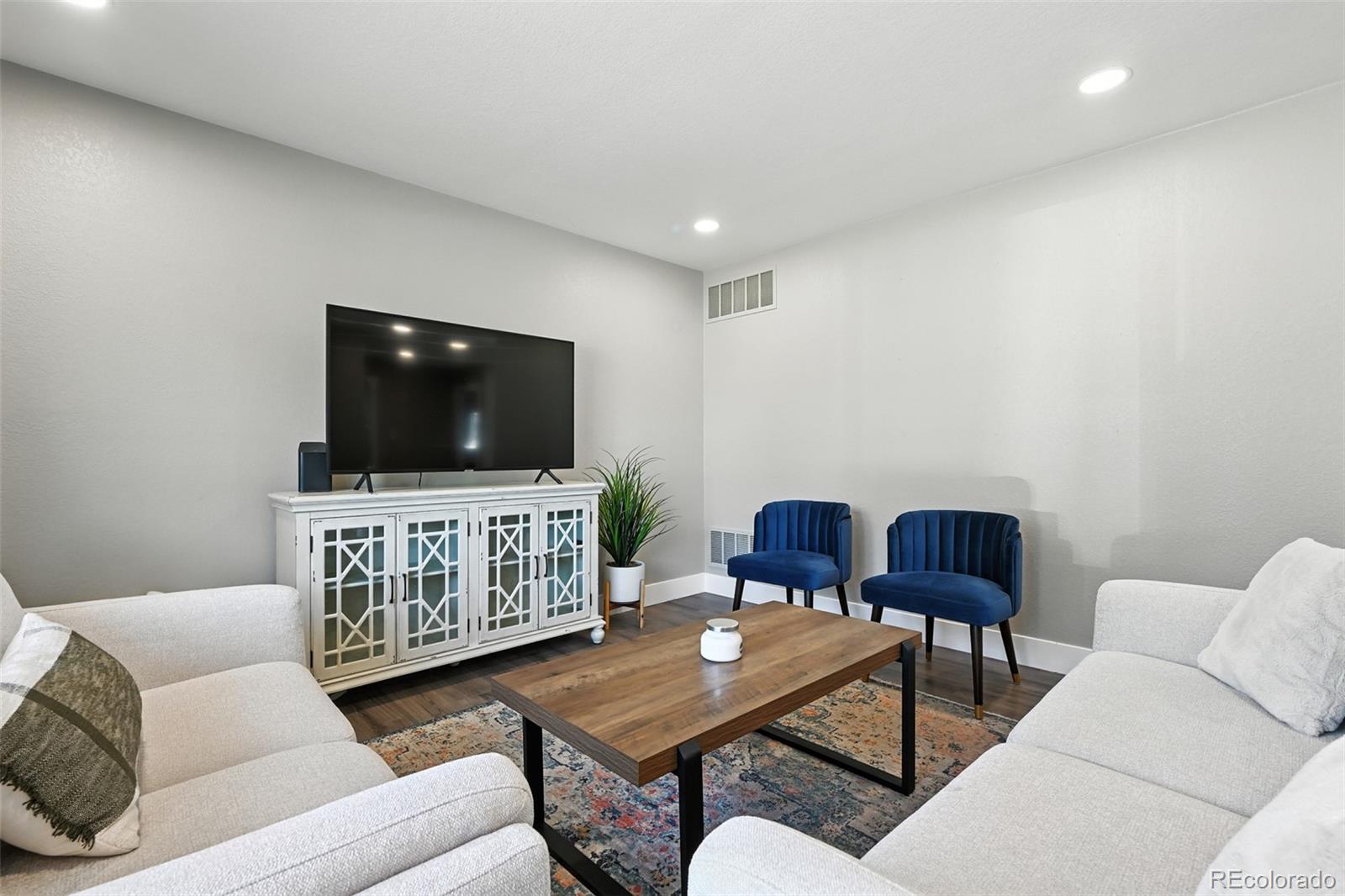 2714 South Raleigh Street Denver, CO 80236 - Photo 5 of 34 a living room with furniture and a flat screen tv