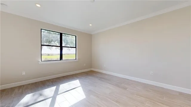a view of a livingroom with wooden floor and a flat screen tv