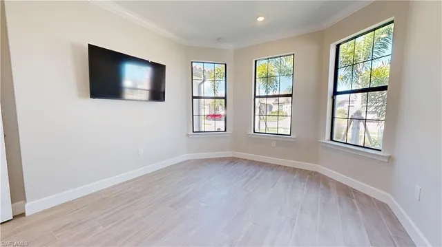 a view of an empty room with wooden floor and closet
