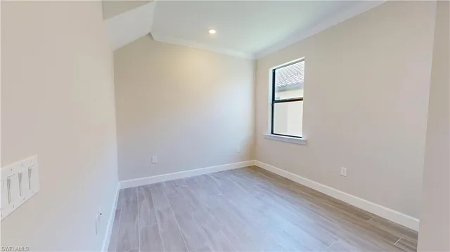 a view of an empty room and wooden floor