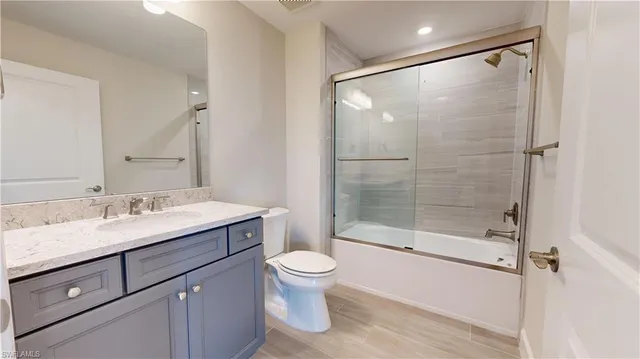 a view of a storage and utility room with wooden floor