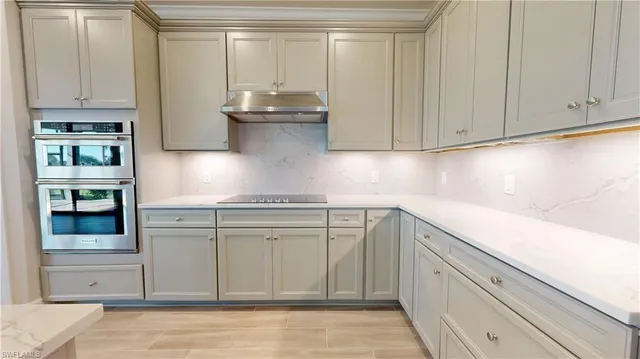 a kitchen with stainless steel appliances granite countertop a sink and cabinets