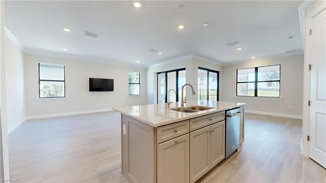 a kitchen with sink stove and wooden floor