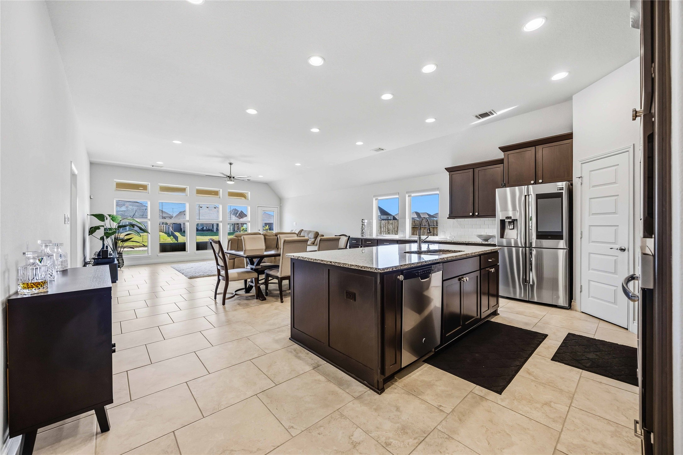2726 Cutter Court Manvel, TX 77578 - Photo 18 of 44 a kitchen with stainless steel appliances a stove a sink a oven a dining table and chairs
