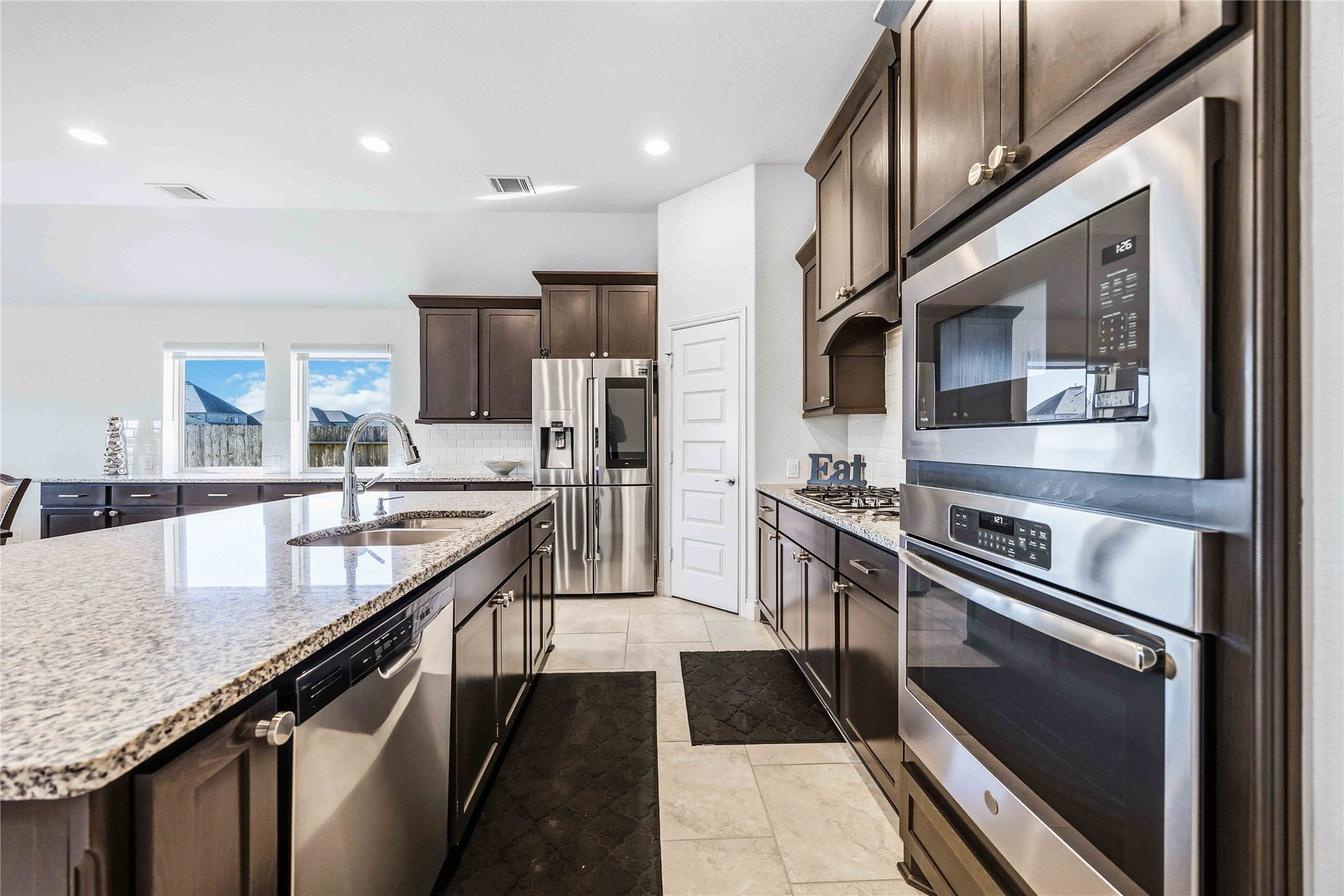 2726 Cutter Court Manvel, TX 77578 - Photo 20 of 44 a kitchen with stainless steel appliances granite countertop a sink a stove and a refrigerator