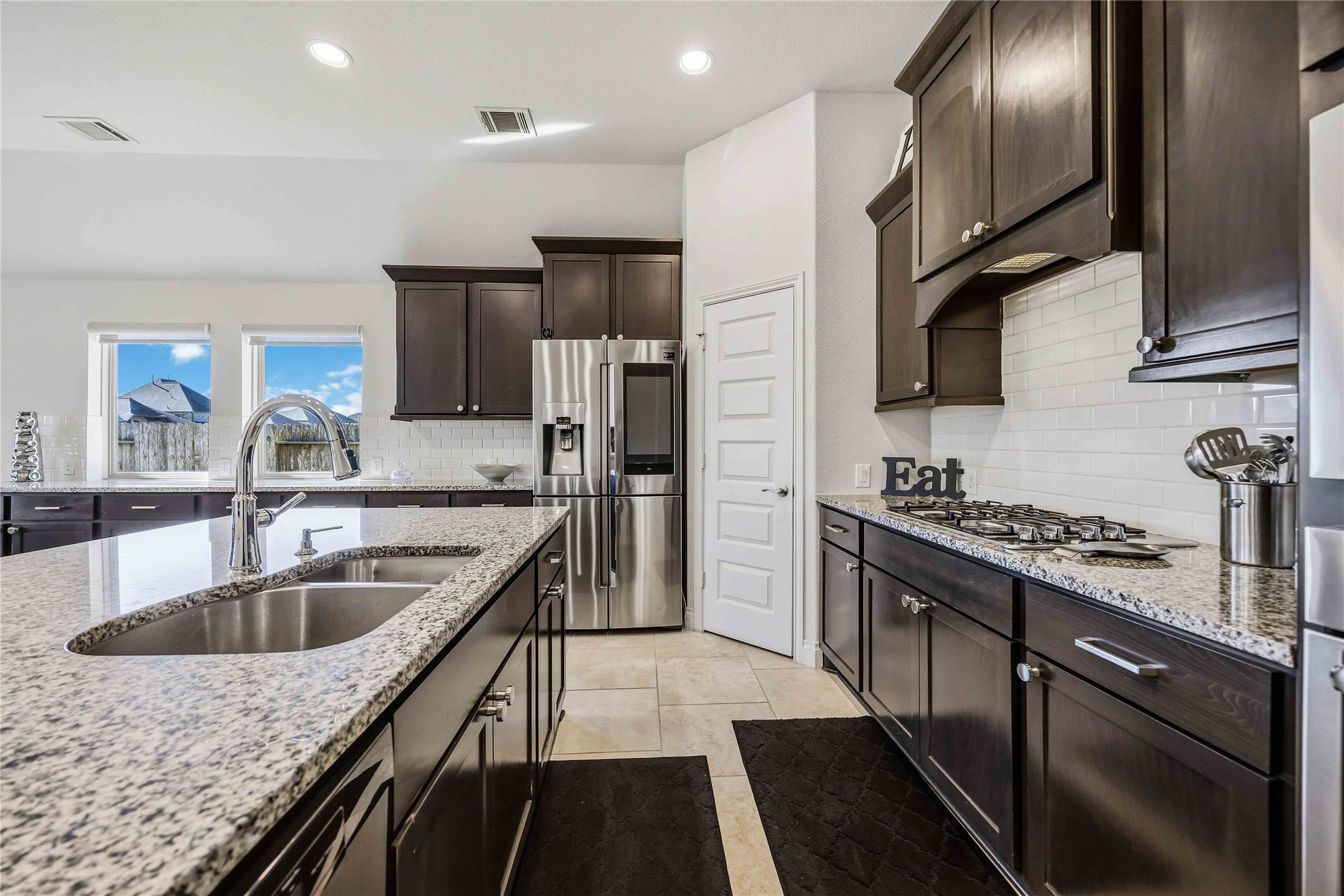 2726 Cutter Court Manvel, TX 77578 - Photo 21 of 44 a kitchen with stainless steel appliances granite countertop a sink stove and refrigerator
