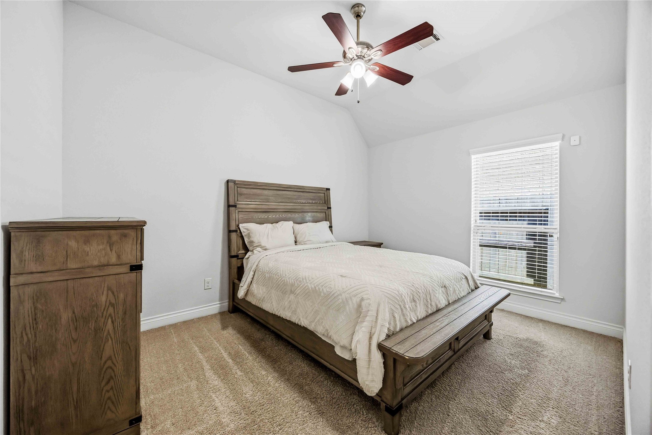 2726 Cutter Court Manvel, TX 77578 - Photo 33 of 44 a bed sitting in a bedroom next to a window and a chandelier