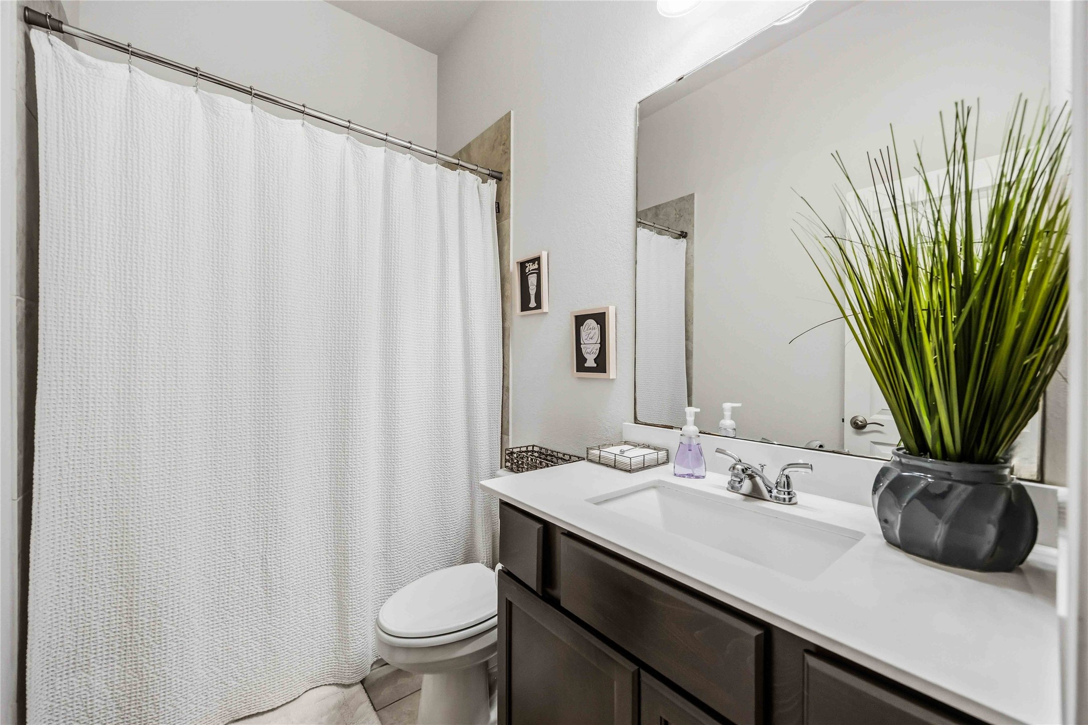 2726 Cutter Court Manvel, TX 77578 - Photo 35 of 44 a bathroom with a granite countertop sink a toilet and a mirror