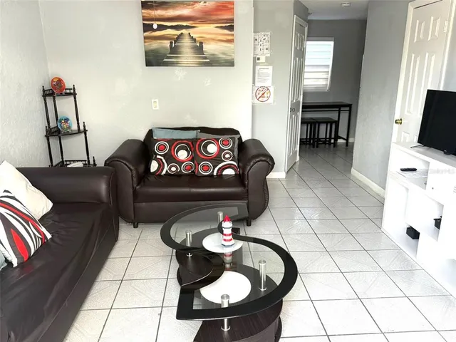 a living room with furniture and a flat screen tv