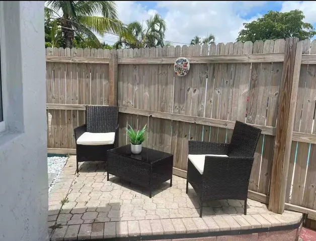 a view of two chairs in the patio