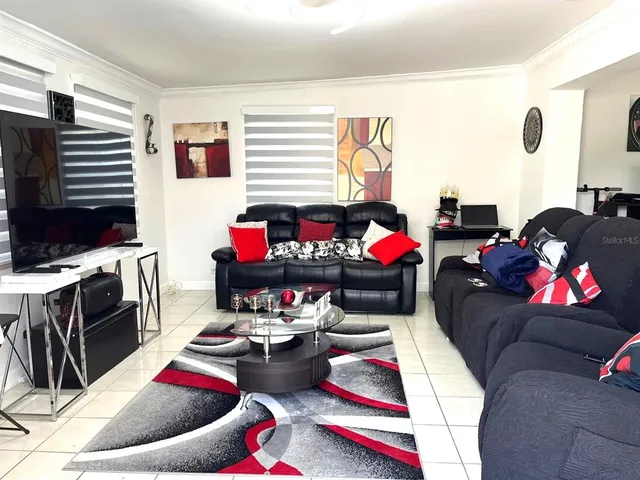 a living room with furniture kitchen and a window