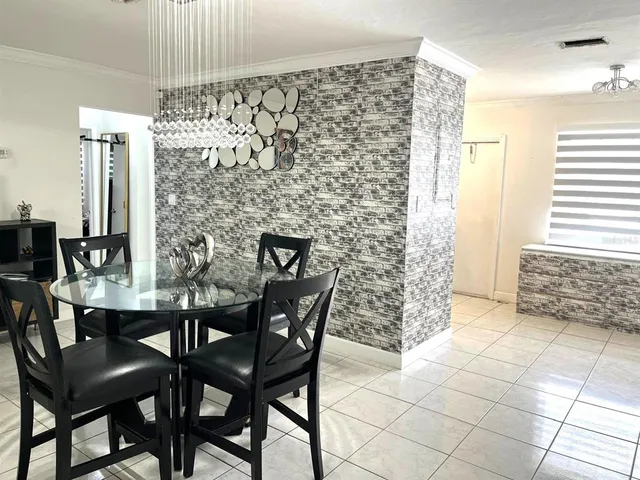 a view of a dining room with furniture and chandelier