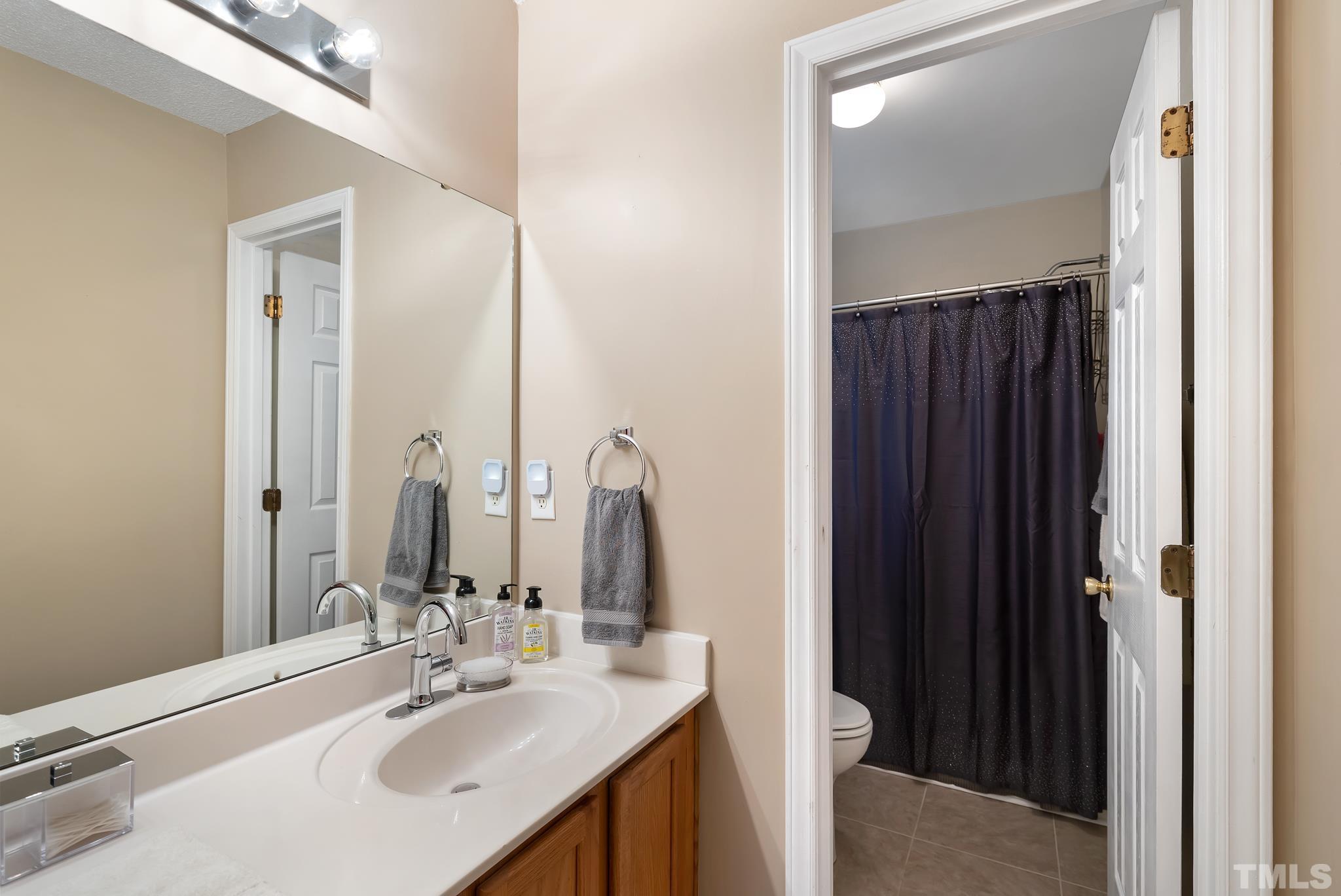 3500 Milky Way Raleigh, NC 27604 - Photo 13 of 30 a bathroom with a double vanity sink and a mirror