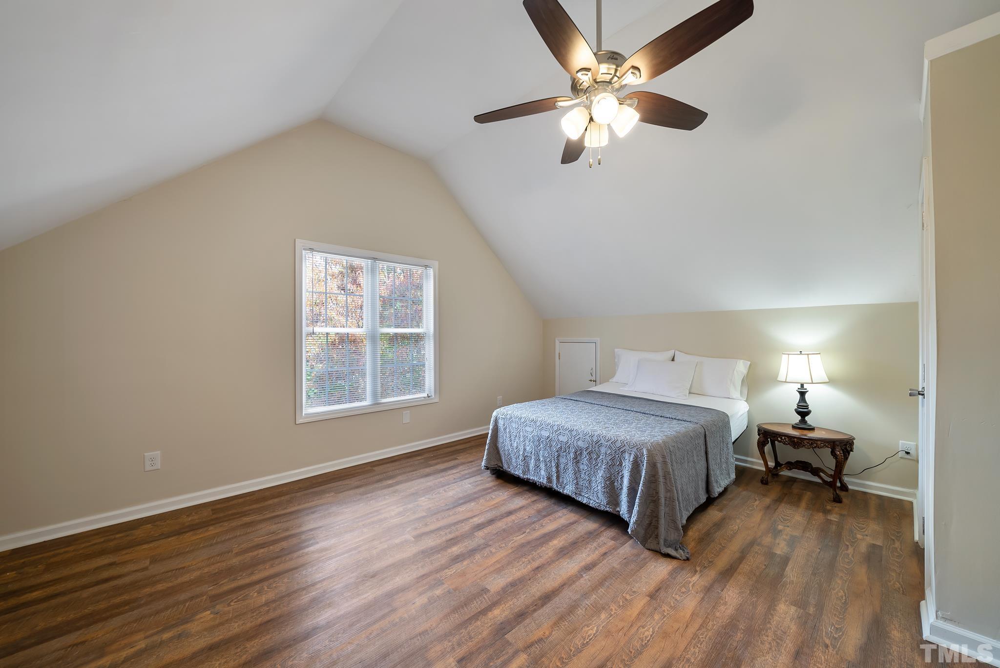 3500 Milky Way Raleigh, NC 27604 - Photo 19 of 30 a spacious bedroom with a large bed chandelier and a window