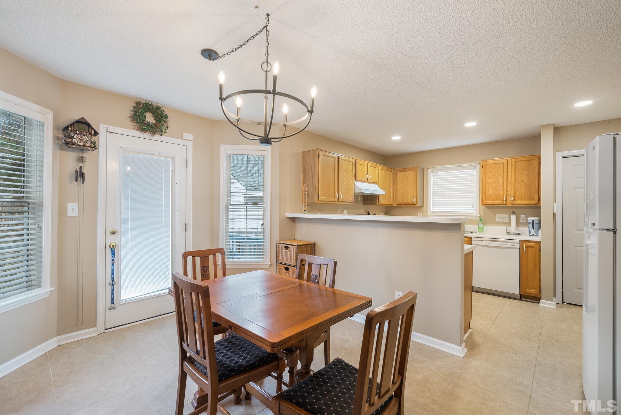 3500 Milky Way Raleigh, NC 27604 - Photo 7 of 30 a view of a dining room with furniture a chandelier and wooden floor