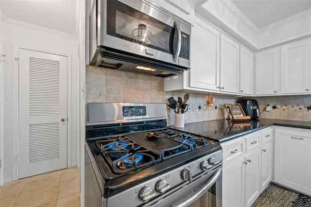 a kitchen with a stove and a microwave