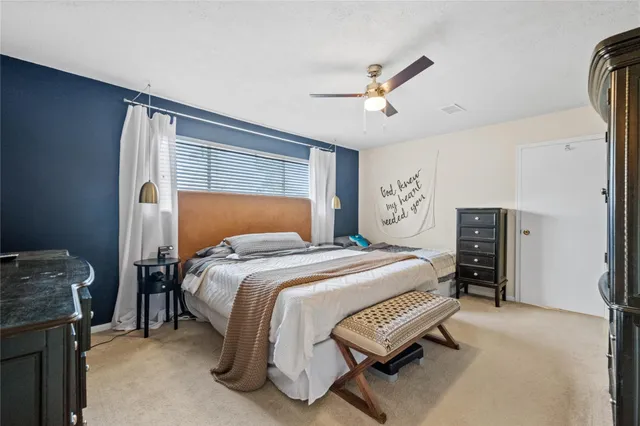 a bedroom with a bed and dresser