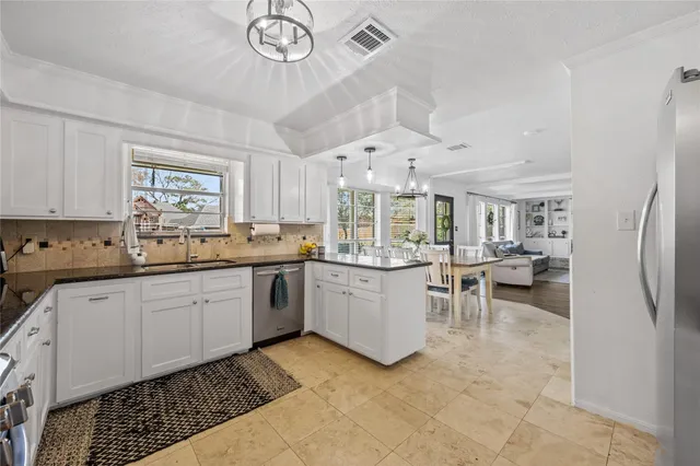 a kitchen with sink cabinets and window
