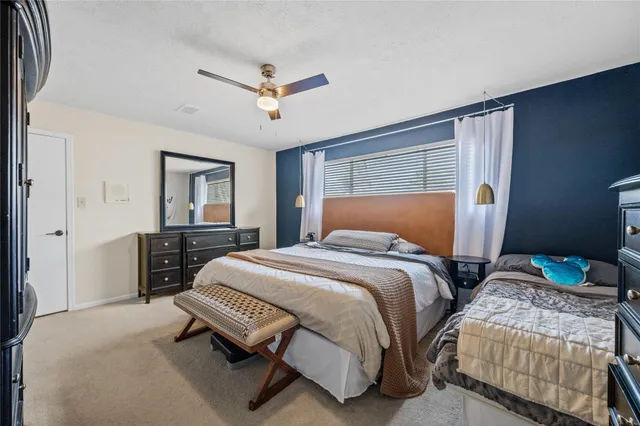 a bedroom with two beds and a chandelier