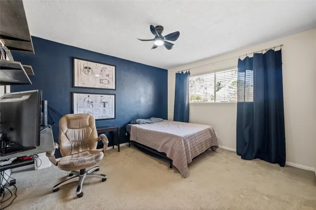 a bedroom with bed and a window