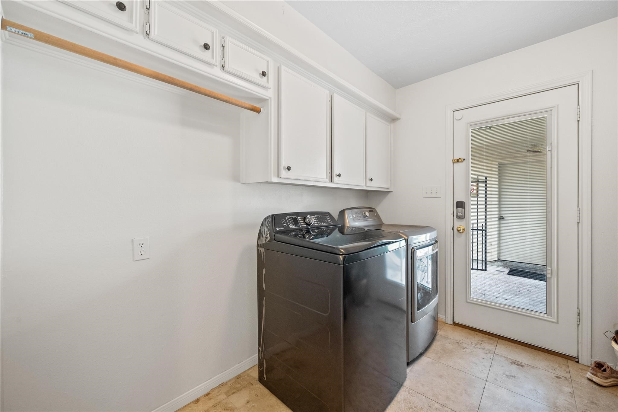 19702 Sweet Forest Lane Humble, TX 77346 - Photo 25 of 30 Large laundry room in house offering a clothes hanging bar and extra cabinets.