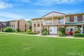 a front view of a house with a yard and porch