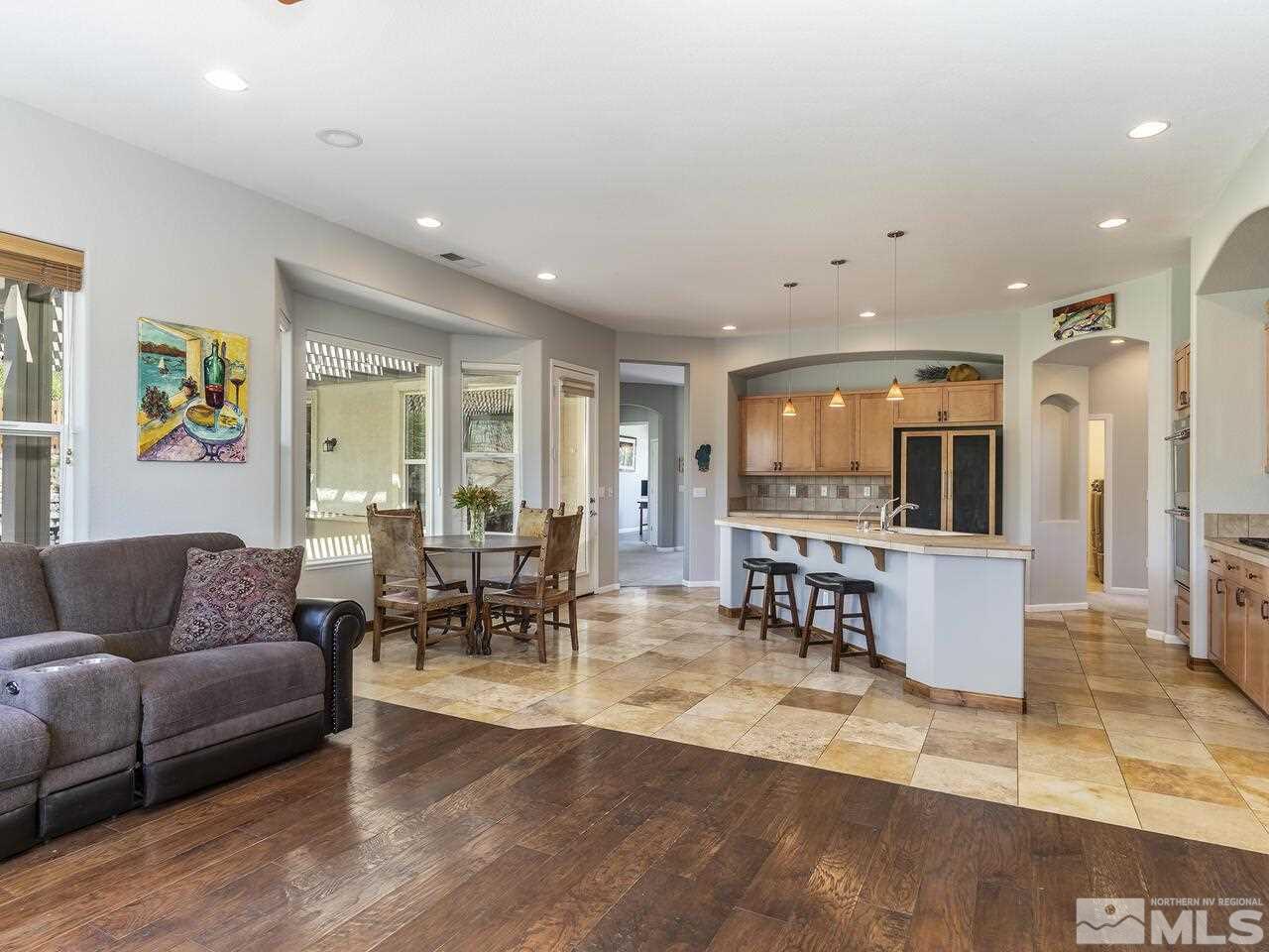 895 Peacepipe Loop Reno, NV 89511 - Photo 15 of 37 a living room with furniture and a dining table with kitchen view