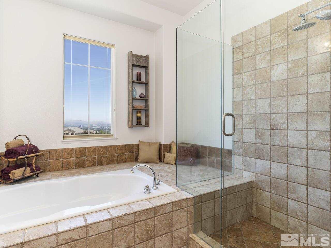895 Peacepipe Loop Reno, NV 89511 - Photo 18 of 37 a bathroom with a tub a sink and a shower
