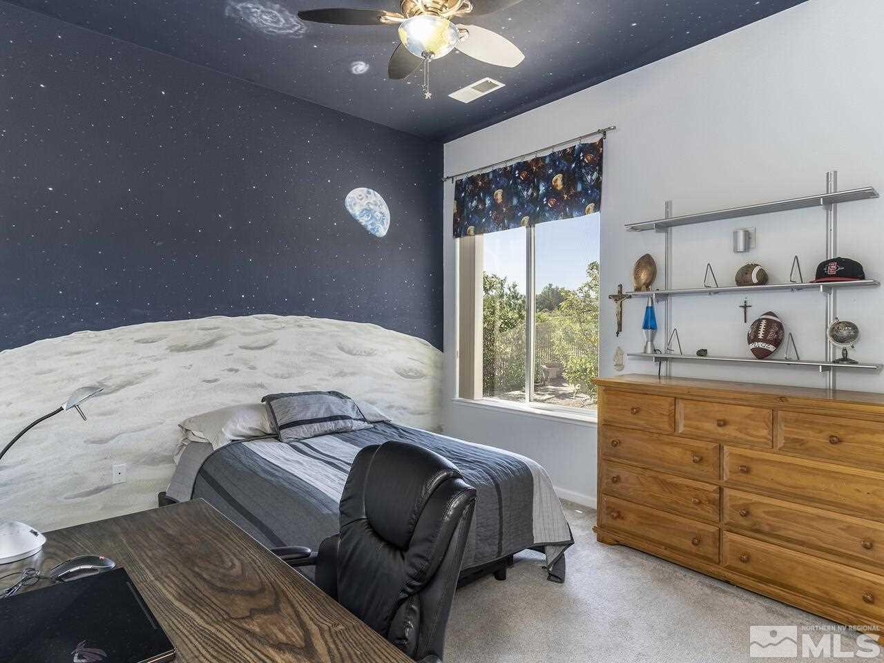 895 Peacepipe Loop Reno, NV 89511 - Photo 19 of 37 a bedroom with a large bed and a window