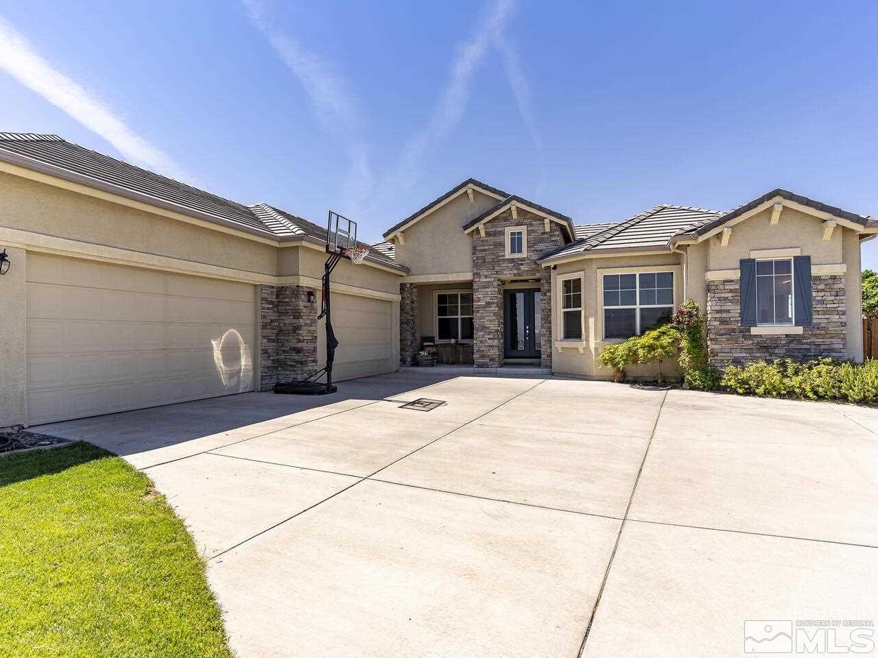 895 Peacepipe Loop Reno, NV 89511 - Photo 2 of 37 a front view of a house with a garden